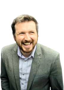 Man looking at the camera and smiling, head and shoulders photo.