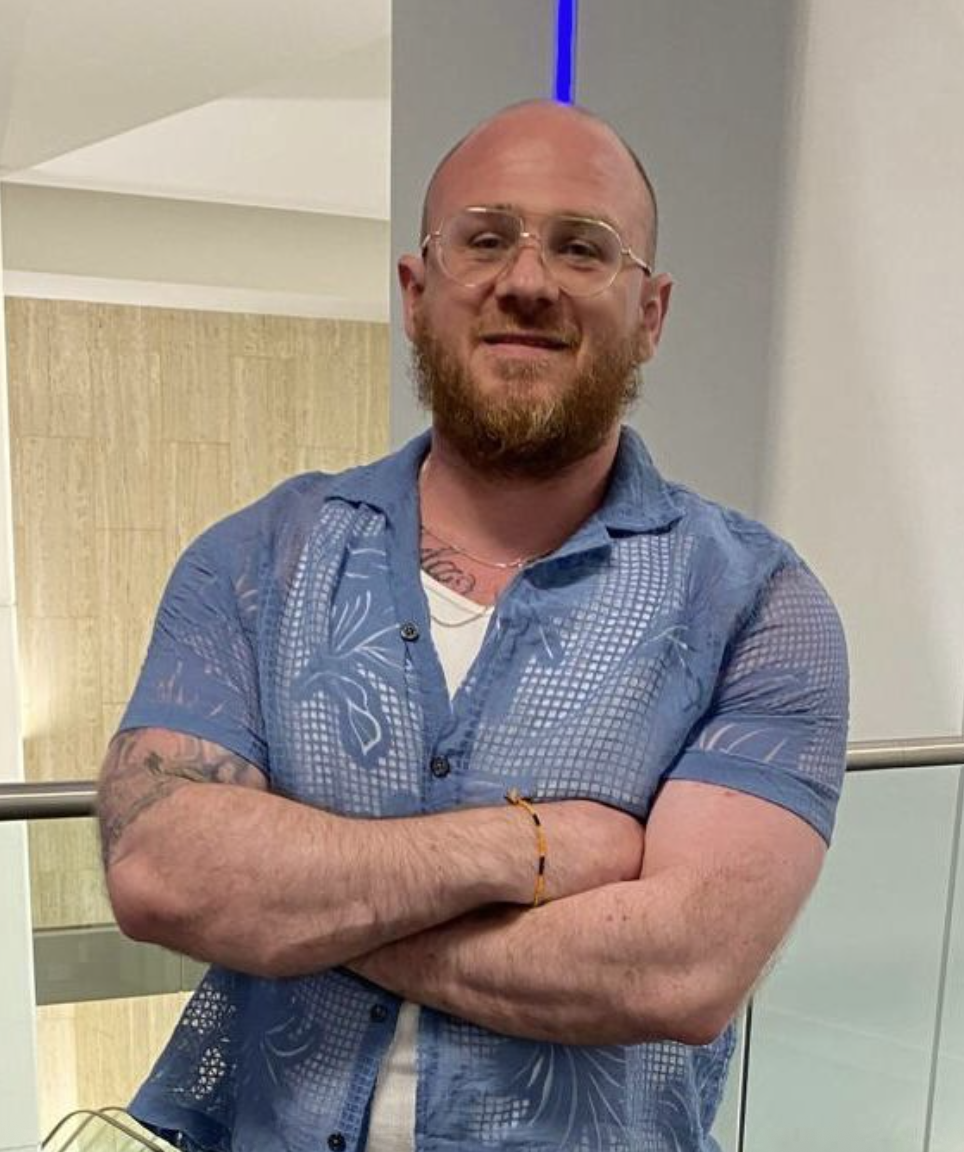 Man looking at the camera and smiling, head and shoulders photo.